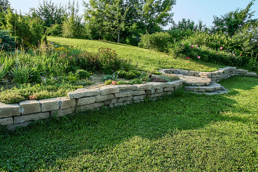 alpine slide and retaining wall on a green in a landscaped garden in the morning sun